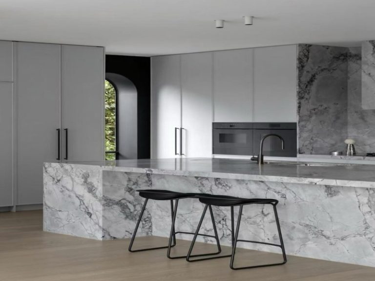 Super White Quartzite waterfall island countertops in a modern luxury kitchen