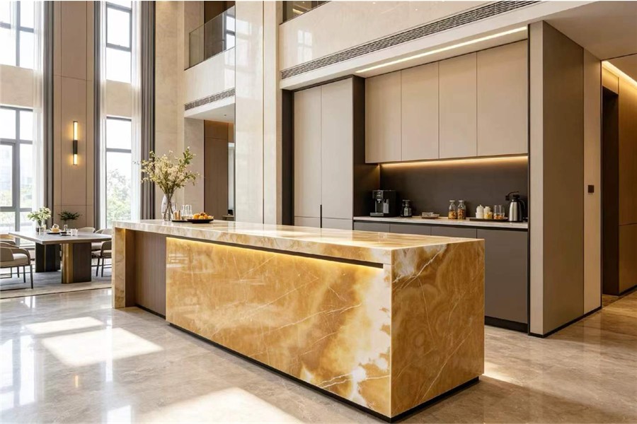 Backlit Orange Onyx kitchen island with warm amber illumination